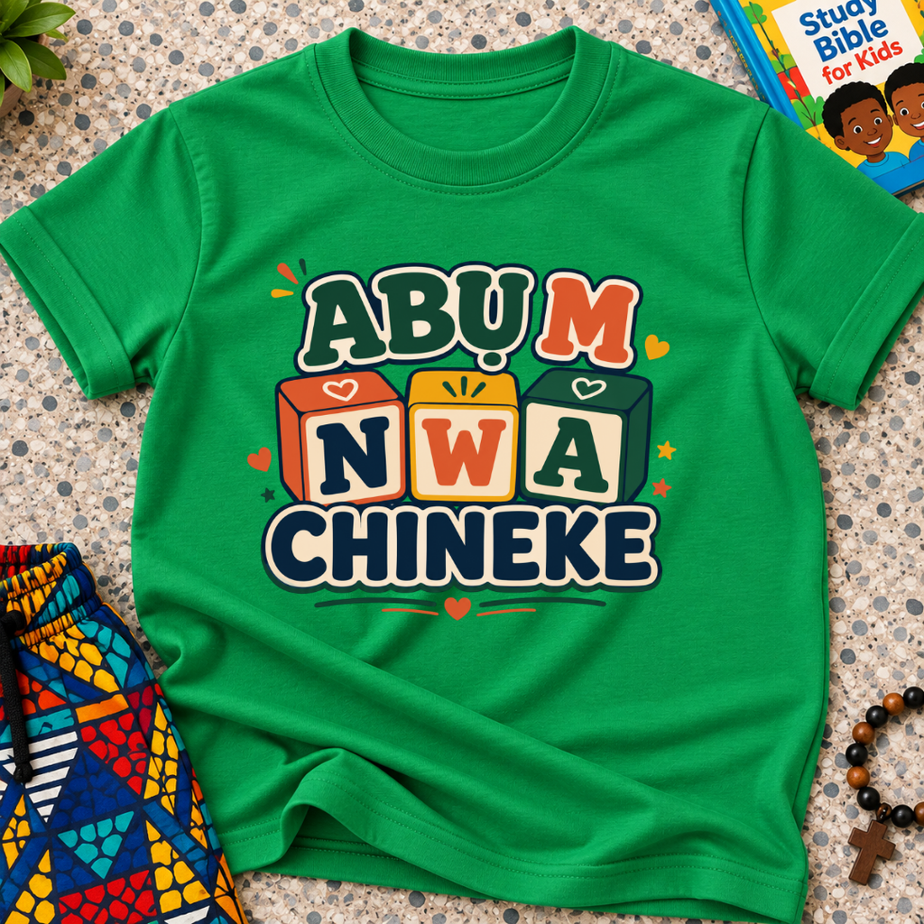 Abụ M Nwa Chineke Igbo Christian kids shirt in green featuring colourful block lettering and decorative accents
