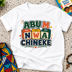 Abụ M Nwa Chineke Igbo Christian kids shirt in white featuring colourful block lettering and decorative accents

