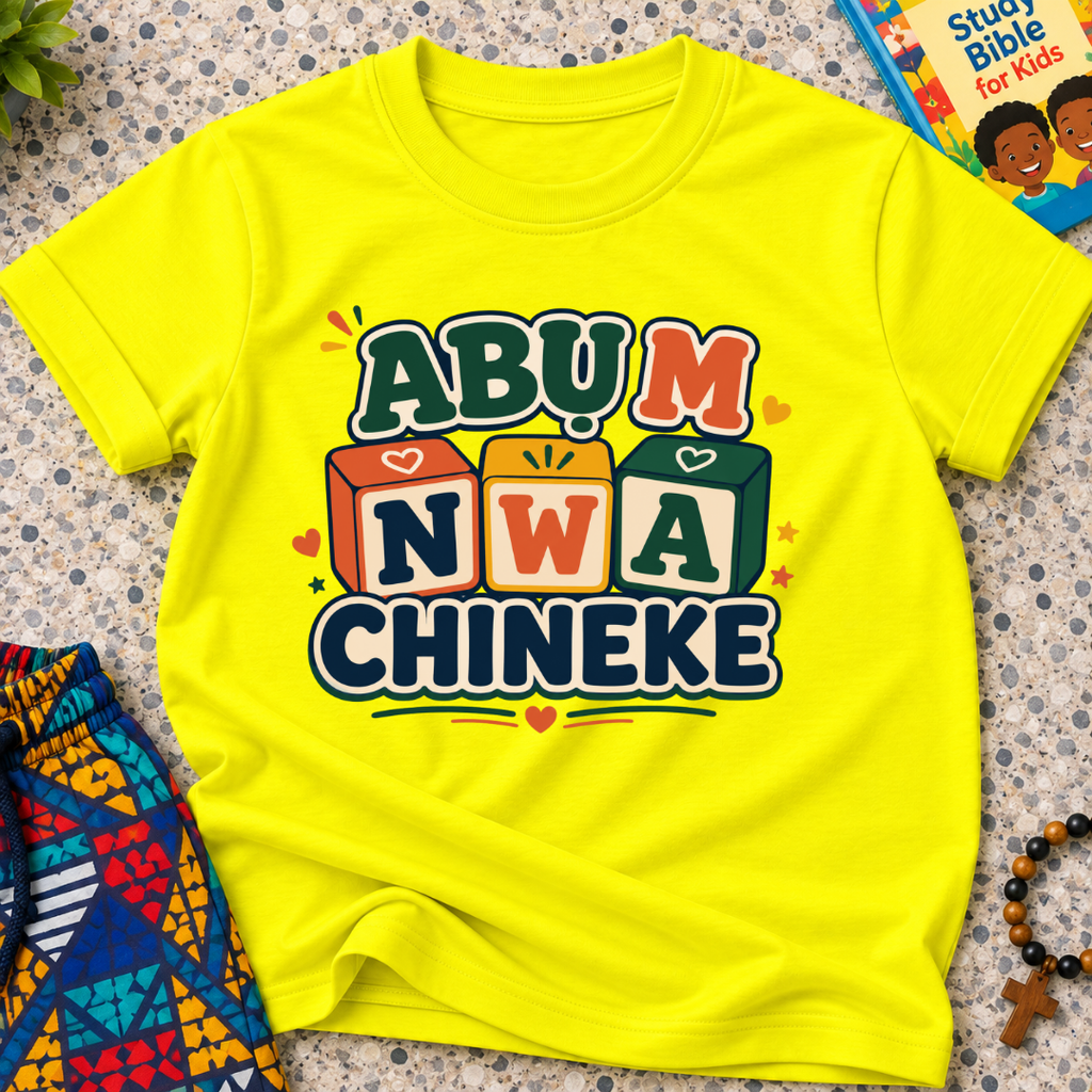 Abụ M Nwa Chineke Igbo Christian kids shirt in yellow featuring colourful block lettering and decorative accents
