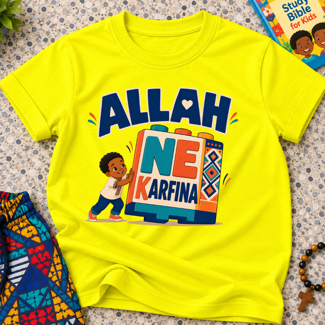 Allah Ne Ƙarfina Hausa-language kids shirt in yellow featuring bold lettering and a child beside colourful blocks
