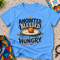 Anointed Blessed Still Hungry Christian kids shirt in light blue featuring bold lettering and food-inspired artwork
