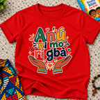 Anụ Ni mo ri Gba kids shirt in red featuring colourful lettering, raised hands, and decorative artwork
