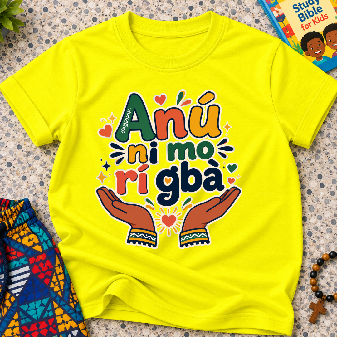 Anụ Ni mo ri Gba kids shirt in yellow featuring colourful lettering, raised hands, and decorative artwork
