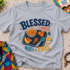 Blessed Loved and Well Fed Christian kids shirt in grey featuring colourful food and family-inspired artwork
