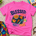 Blessed Loved and Well Fed Christian kids shirt in pink featuring colourful food and family-inspired artwork

