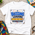 Blessing Loading Christian kids shirt in white featuring a colourful progress bar and God Is Not Finished Yet message
