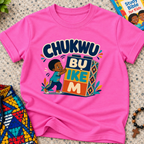 Chukwu Bụ Ike M Igbo Christian kids shirt in pink featuring bold lettering and a child beside colourful blocks
