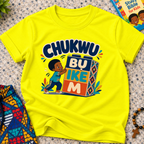 Chukwu Bụ Ike M Igbo Christian kids shirt in yellow featuring bold lettering and a child beside colourful blocks
