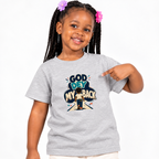 God Dey My Back Christian kids shirt in light grey featuring a child illustration and bold Nigerian Pidgin faith message

