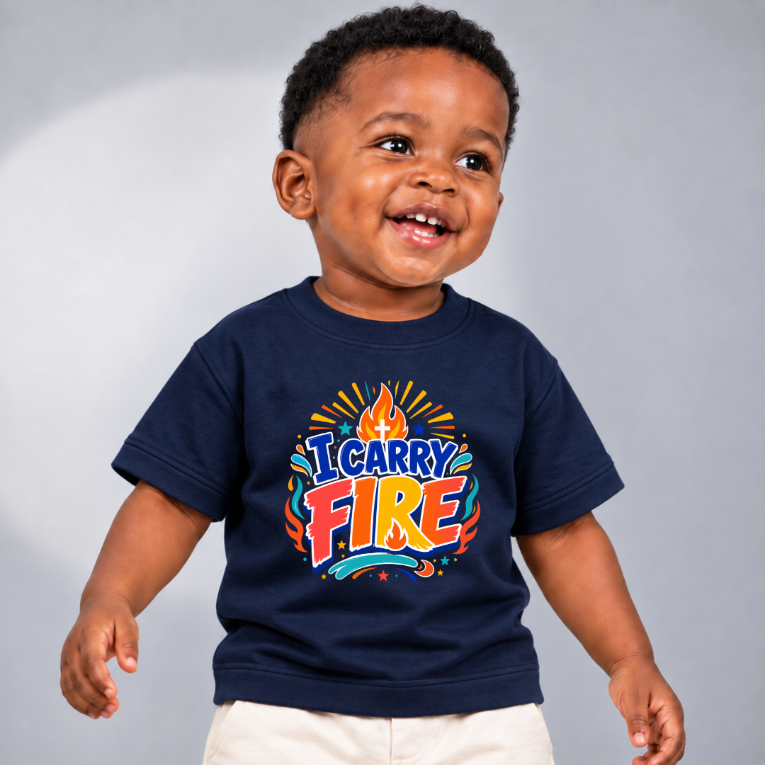 I Carry Fire Christian kids shirt in navy blue featuring bold lettering, flames, and a faith-inspired cross

