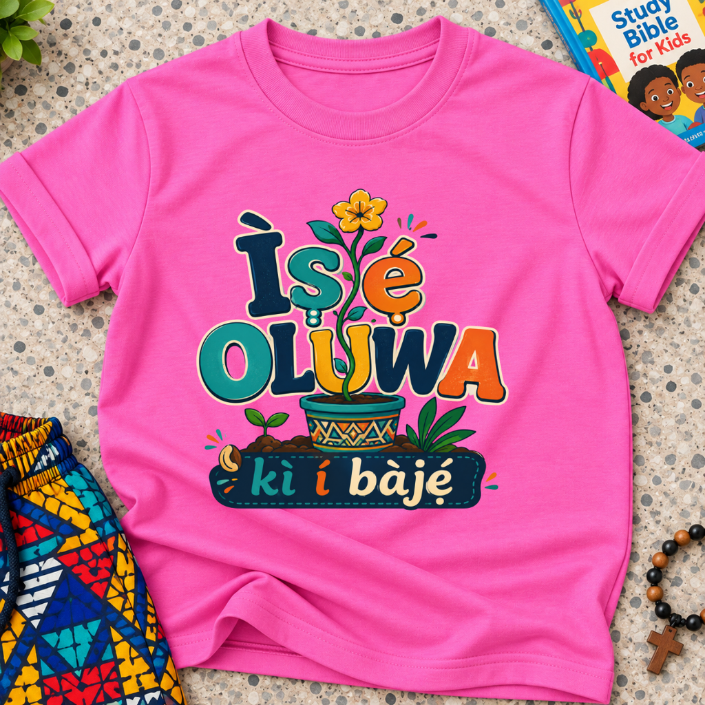 Ìṣẹ́ Olúwa Kì Í Bàjẹ́ Yoruba Christian kids shirt in pink featuring colourful lettering and Nigerian-inspired decorative artwork
