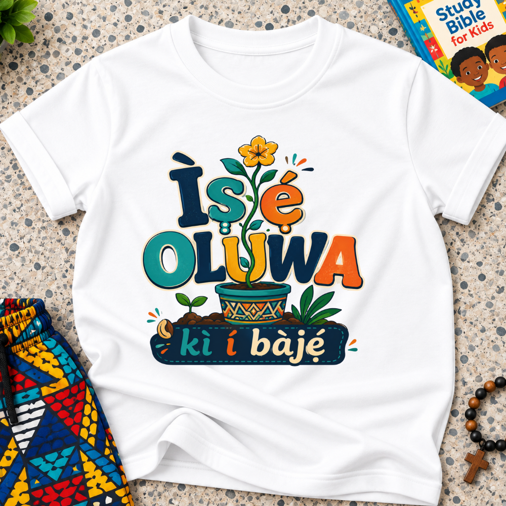 Ìṣẹ́ Olúwa Kì Í Bàjẹ́ Yoruba Christian kids shirt in white featuring colourful lettering and Nigerian-inspired decorative artwork
