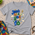 Jésù Lọ́n Gbẹ Mi Fọ Yoruba Christian kids shirt in grey featuring colourful lettering, clouds, and star illustrations
