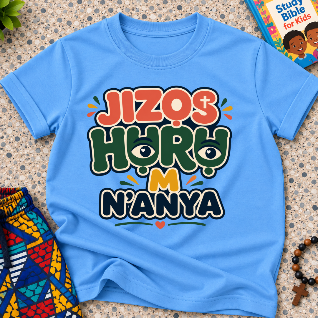 Jizọs Huru M N'anya Igbo Christian kids shirt in light blue featuring bold colourful lettering and decorative accents
