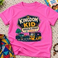 Kingdom Wahala-Proof by Grace Christian kids shirt in pink featuring a colourful Nigerian bus and faith-inspired artwork
