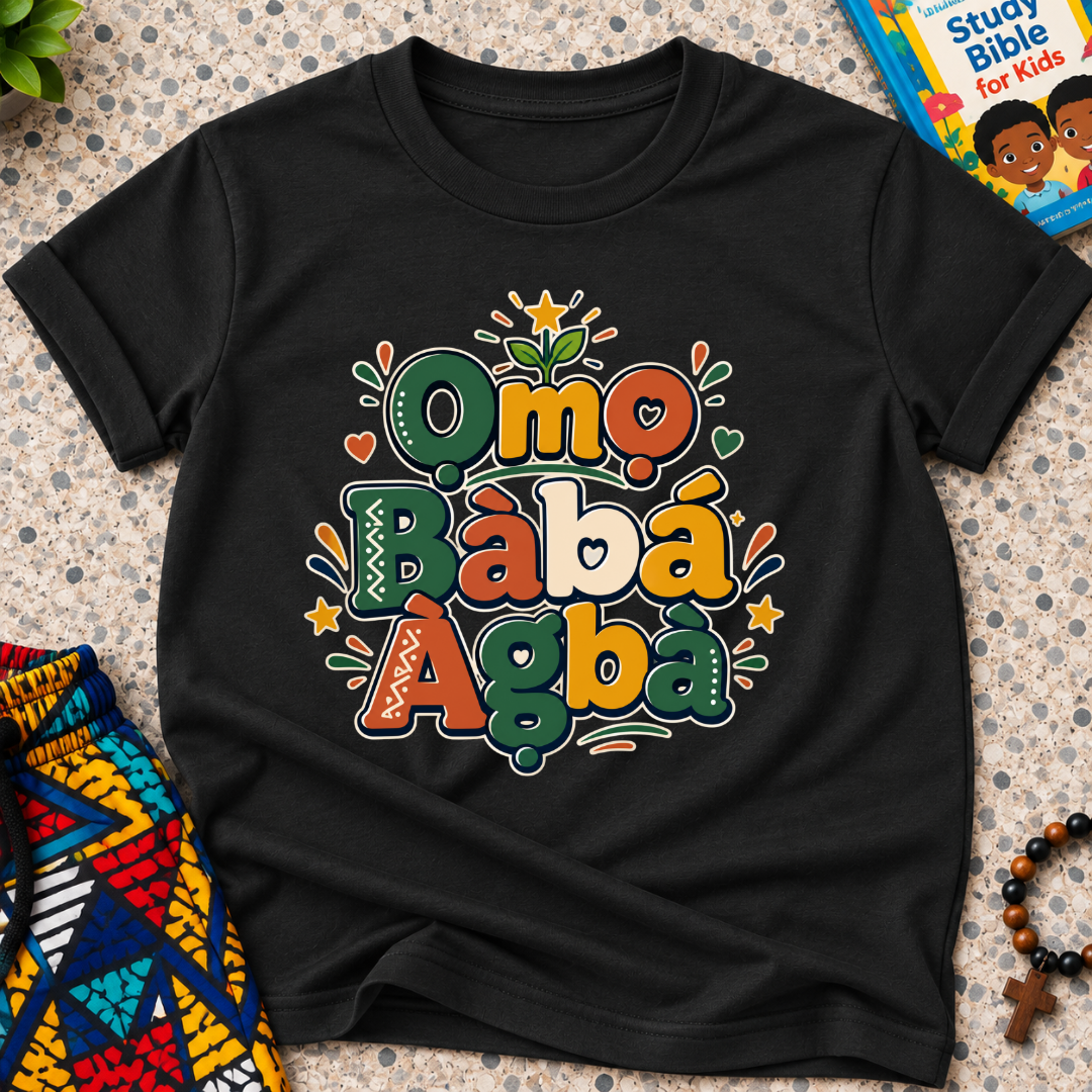 Ọmọ Bàbá Àgbà Yoruba-language kids shirt in black featuring colourful lettering, decorative leaves, and playful accents