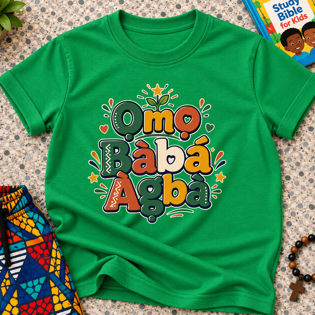 Ọmọ Bàbá Àgbà Yoruba-language kids shirt in green featuring colourful lettering, decorative leaves, and playful accents