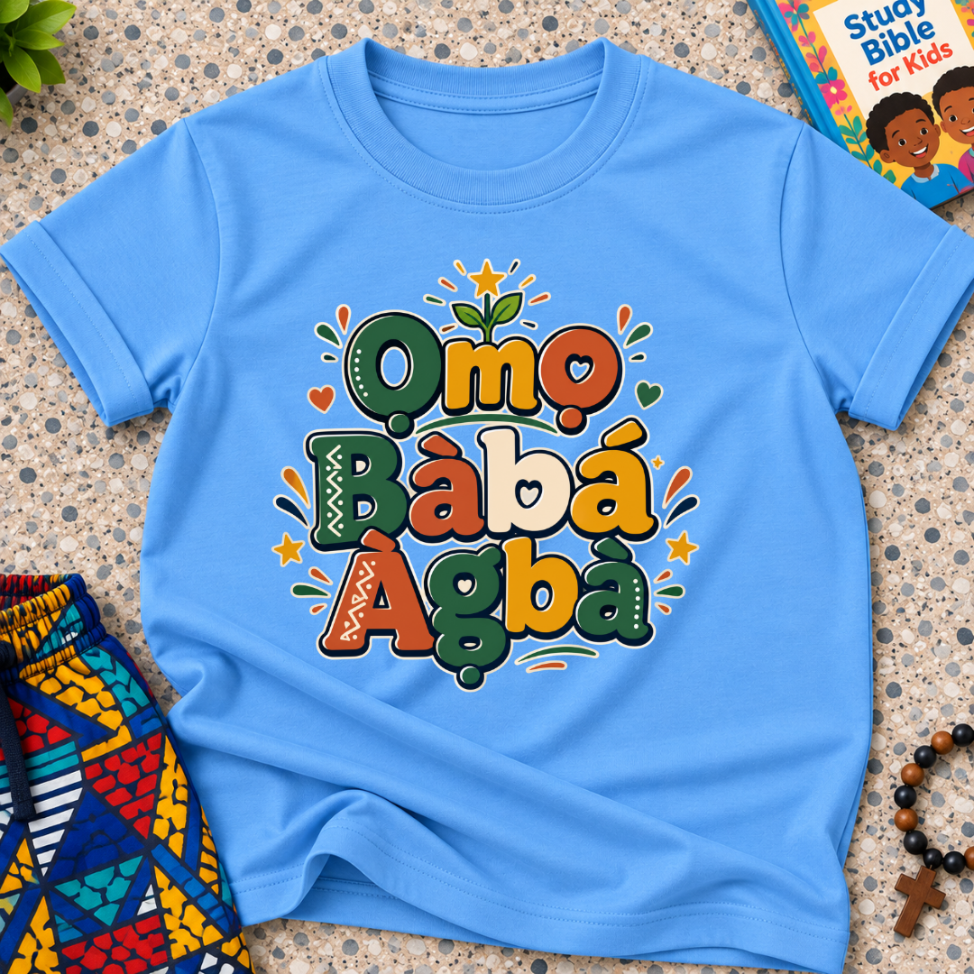 Ọmọ Bàbá Àgbà Yoruba-language kids shirt in light blue featuring colourful lettering, decorative leaves, and playful accents