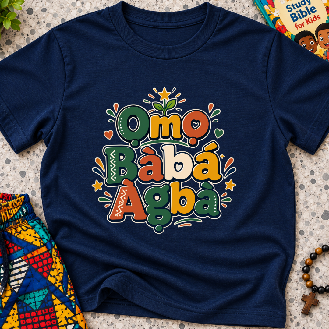 Ọmọ Bàbá Àgbà Yoruba-language kids shirt in navy blue featuring colourful lettering, decorative leaves, and playful accents