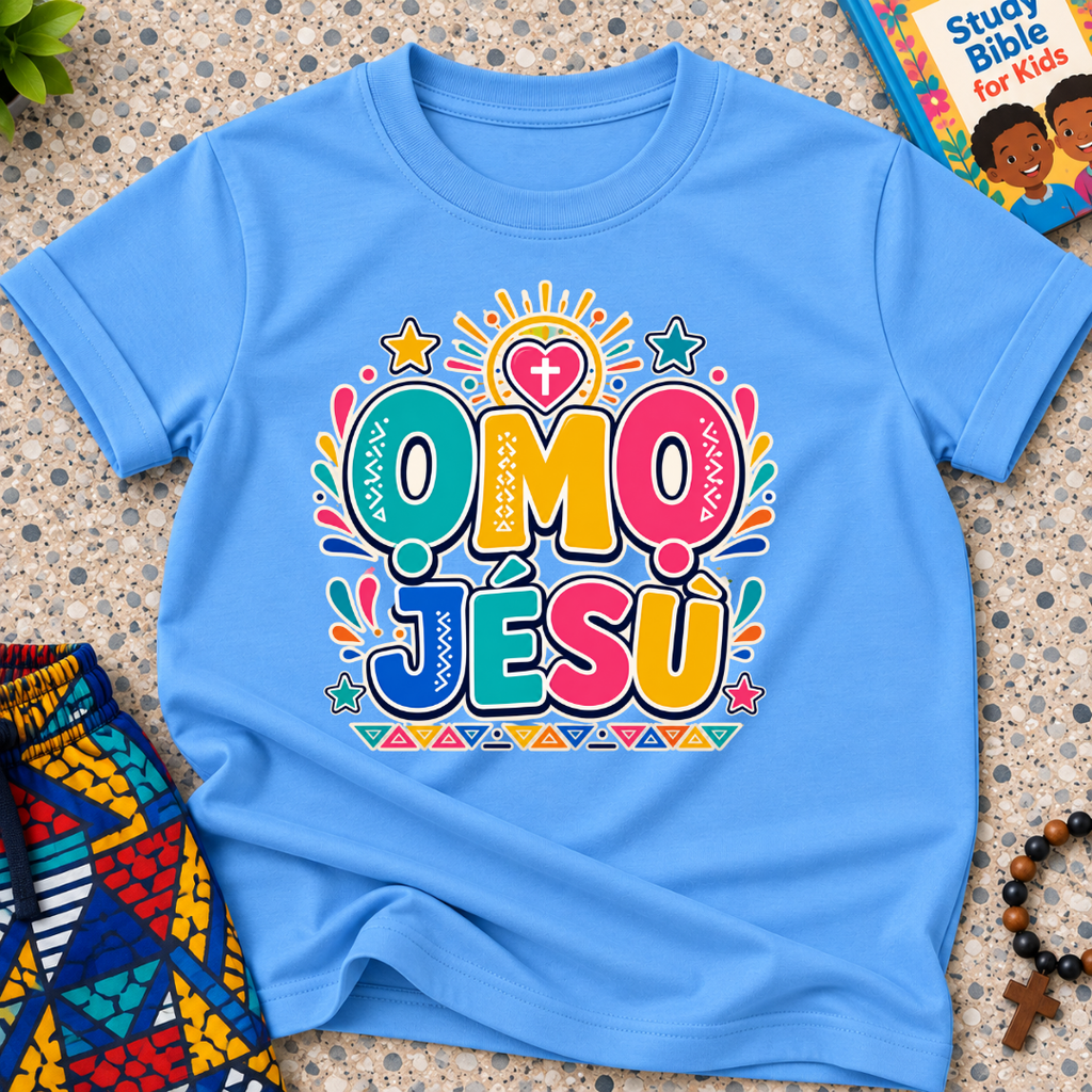 Ọmọ Jésù Yoruba Christian kids shirt in light blue featuring colourful lettering and playful faith-inspired decorations
