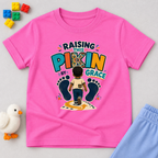Raising This Pikin by Grace Christian kids shirt in pink featuring a child illustration and playful Nigerian parenting message
