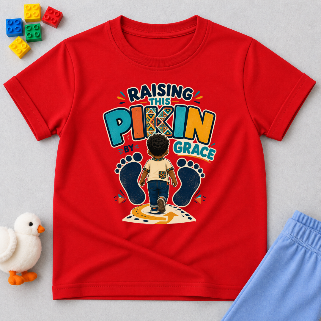 Raising This Pikin by Grace Christian kids shirt in red featuring a child illustration and playful Nigerian parenting message
