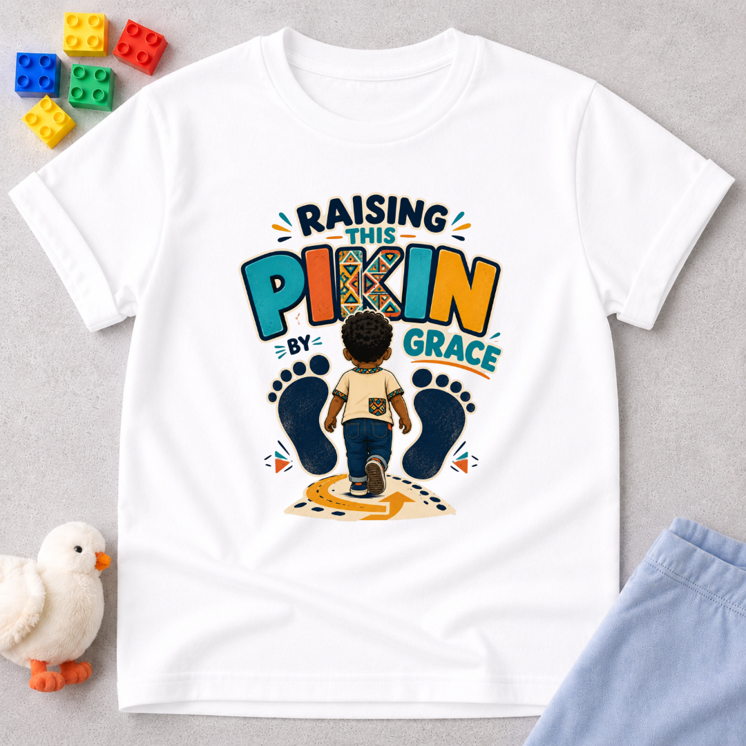 Raising This Pikin by Grace Christian kids shirt in white featuring a child illustration and playful Nigerian parenting message
