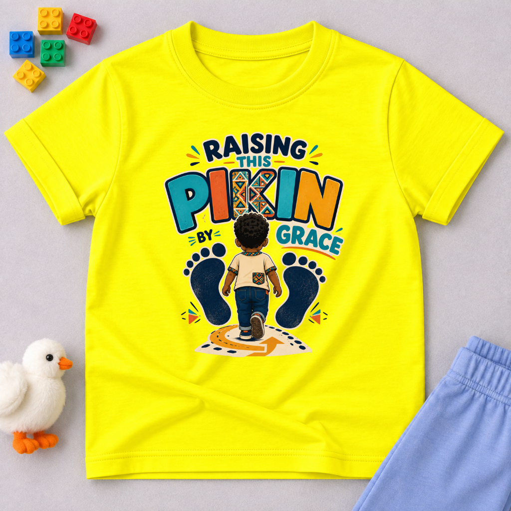 Raising This Pikin by Grace Christian kids shirt in yellow featuring a child illustration and playful Nigerian parenting message
