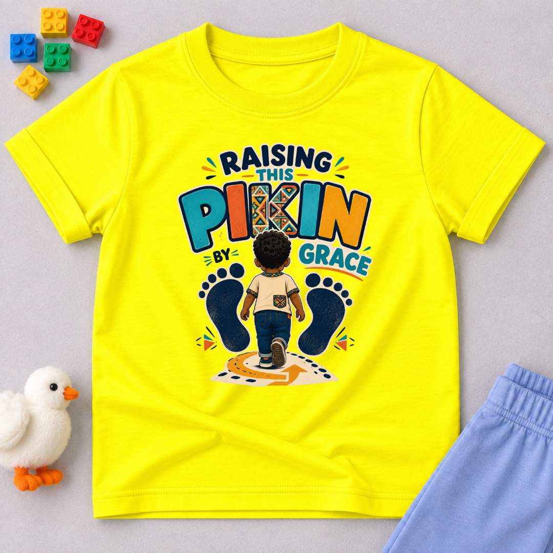 Raising This Pikin by Grace Christian kids shirt in yellow featuring a child illustration and playful Nigerian parenting message
